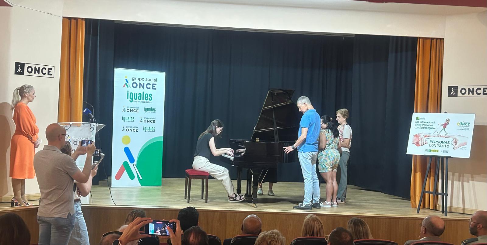 La pianista Águeda Mesa toca el piano y los afiliados con sordoceguera sienten la vibración